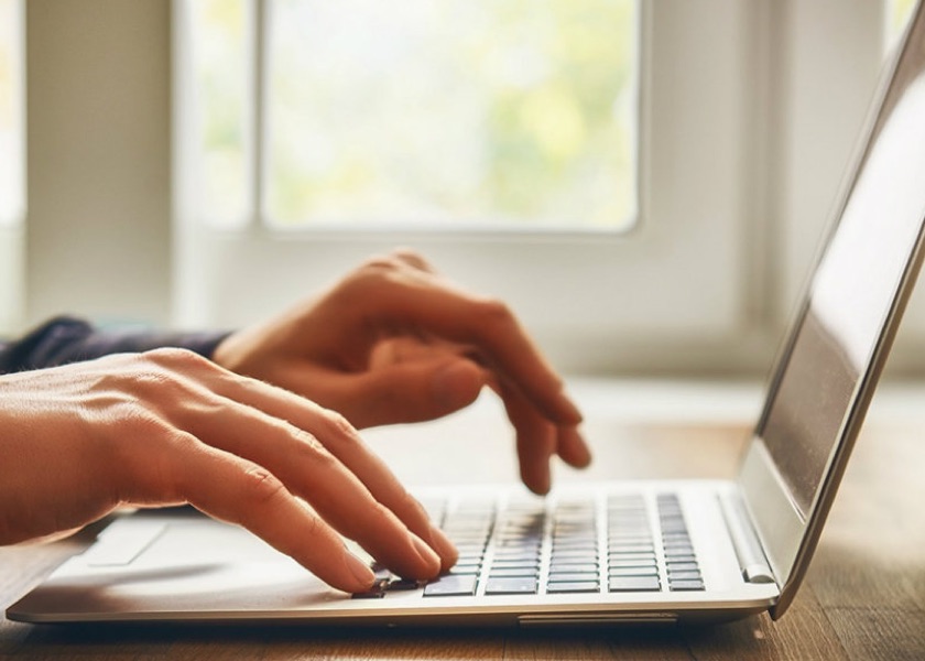 hands typing on computer